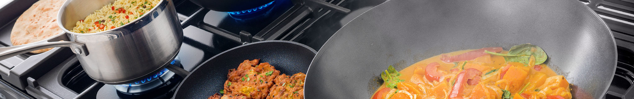 Falcon Dual Fuel hob with pans with various contents